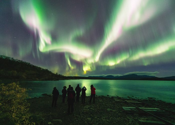 Northern lights over a small, remote cabin